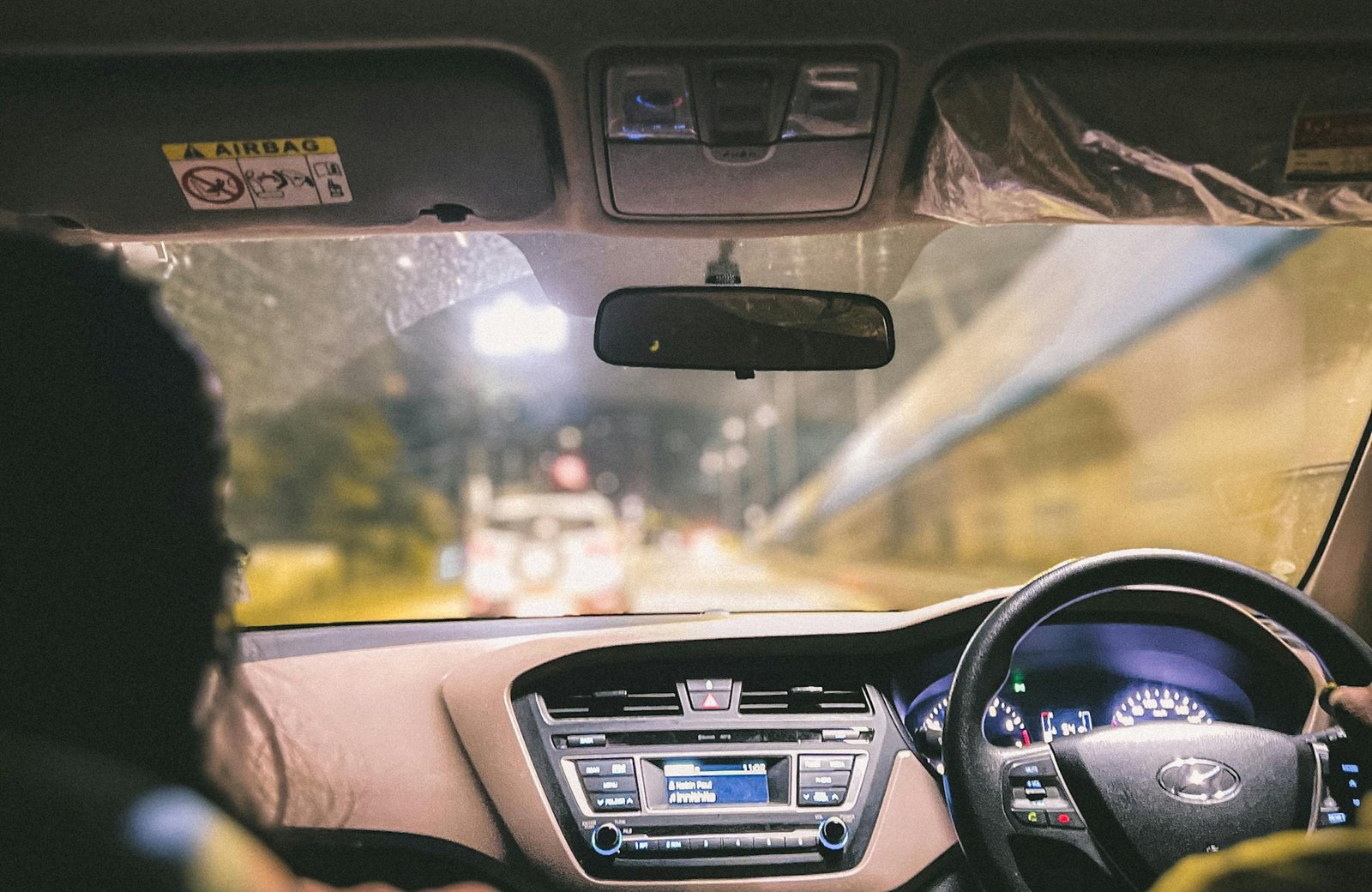 Night drive from the back seat with dashboard lights visible
